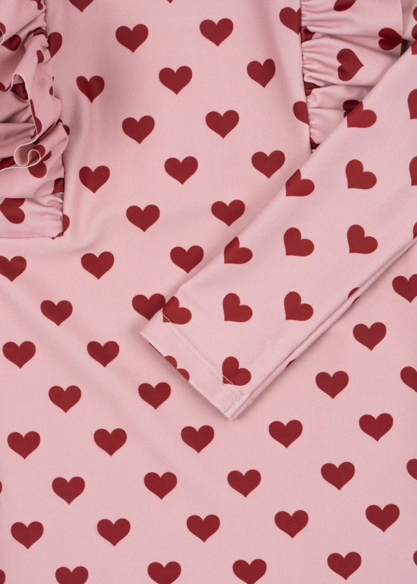 Konges Sloejd | Manuca Frill Onesie in Amour Pink: UPF 50+ Heart Pattern Sun Protection - Image 4