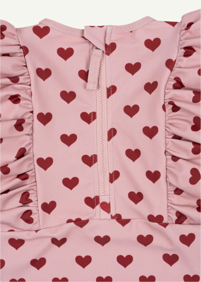 Konges Sloejd | Manuca Frill Onesie in Amour Pink: UPF 50+ Heart Pattern Sun Protection - Image 5